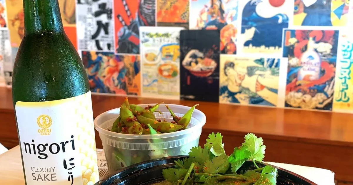 A shared drink and appetizer spread at Bakudan Ramen