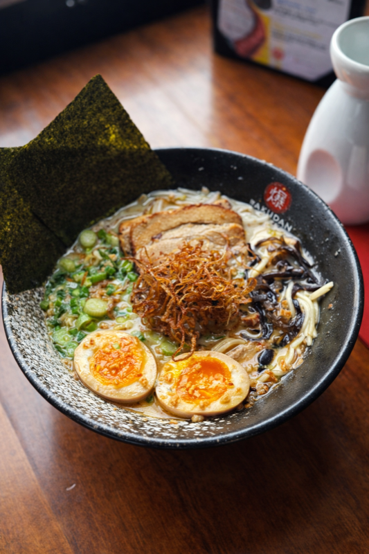 Garlic Tonkotsu Ramen bowl with pork chashu, egg, and garlic chips